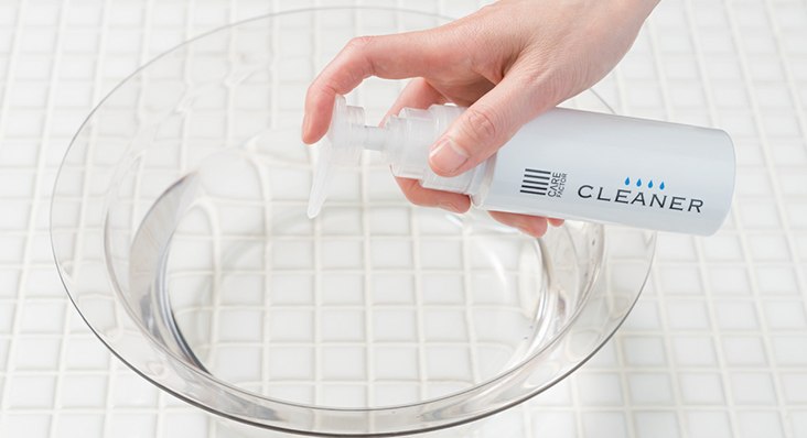 洗面器の水に専用クリーナーを加えている様子